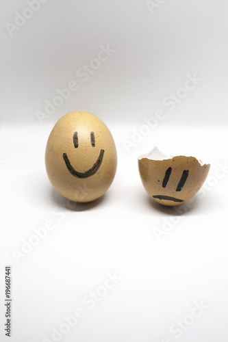 Story of broken heart written by the shells of eggs on the white background