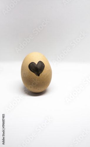 heart written on the egg on the light background