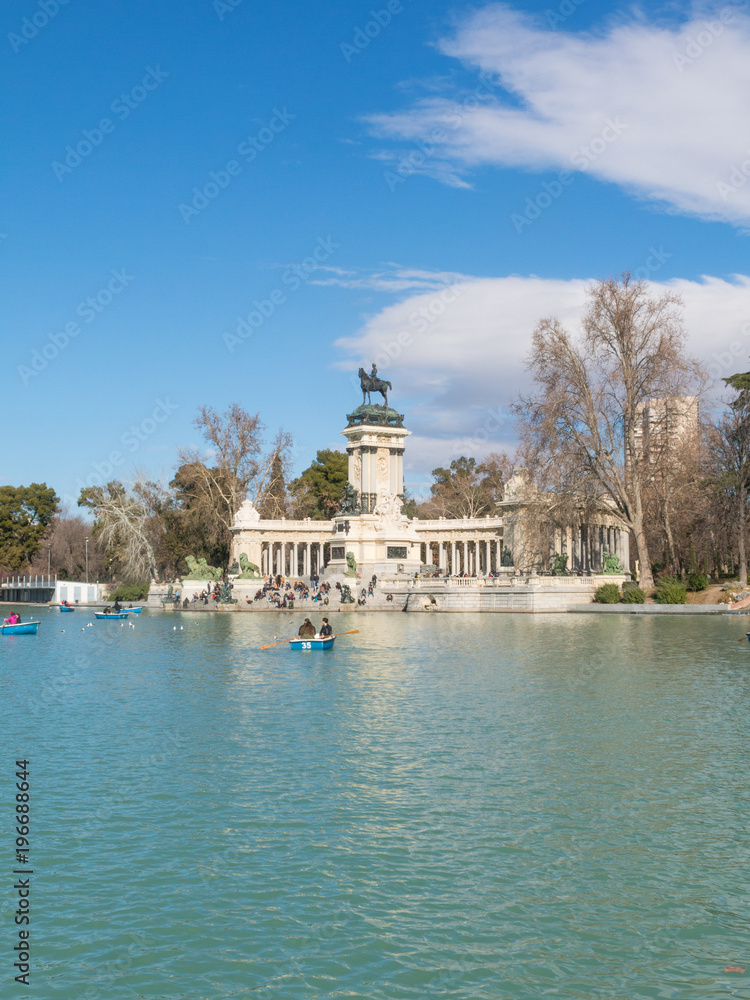 Fototapeta premium People enjoying a boat ride on the pond in El Retiro Park in Madrid, Spain.