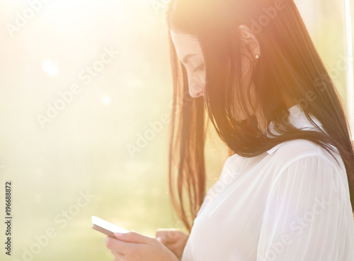 close-up of a young woman with a smartphone.