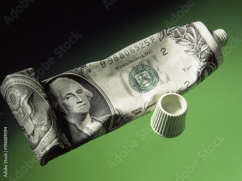 deflation economy reserve currency US dollar wrapped on toothpaste tube photo