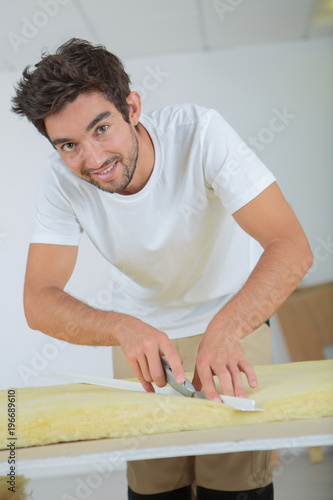 plasterer cutting a foam photo
