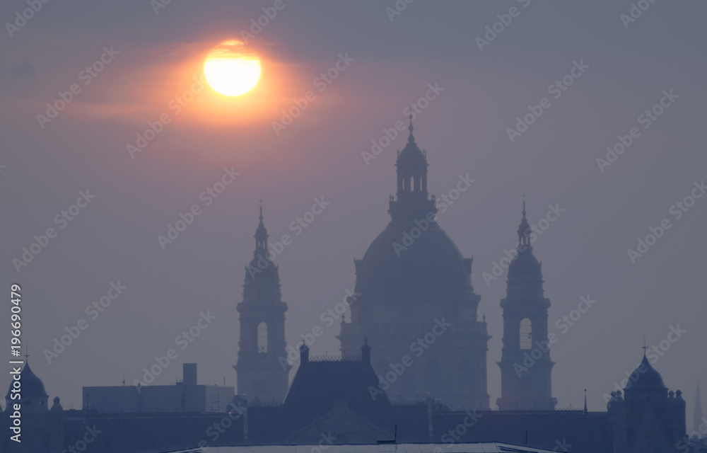 St. Stephen's basilica domes in mist against sunrise. Budapest, Hungary