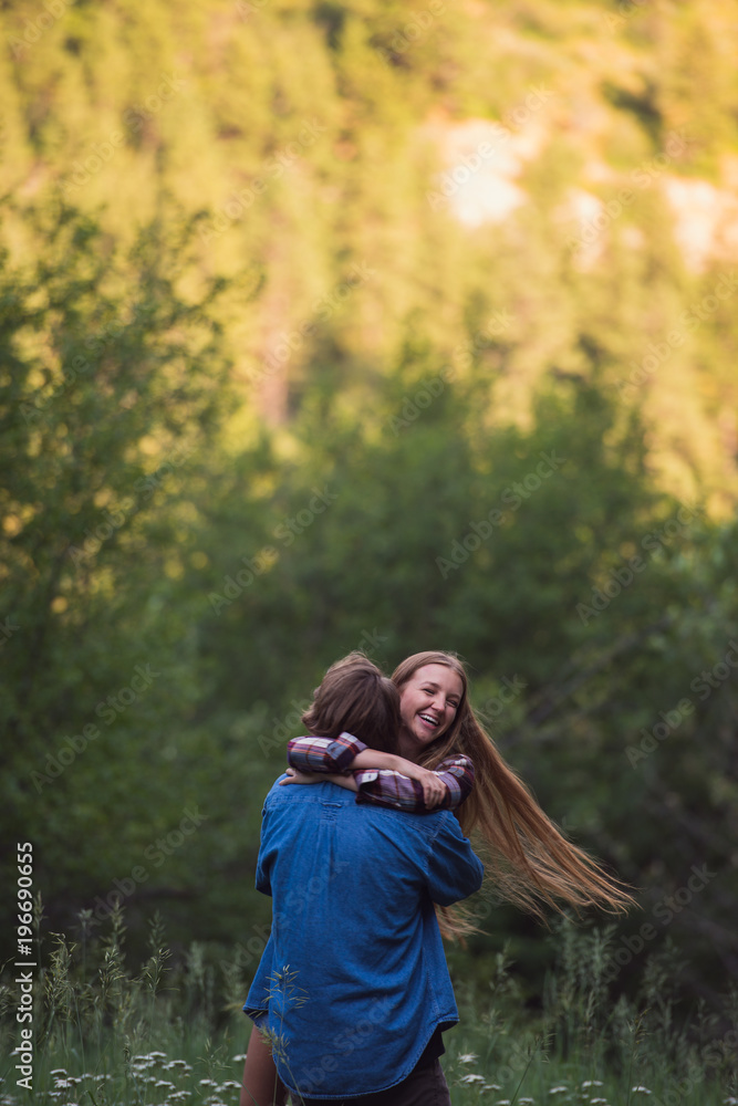Couple enjoying romantic walk through the woods Couple enjoying romantic walk through the woods