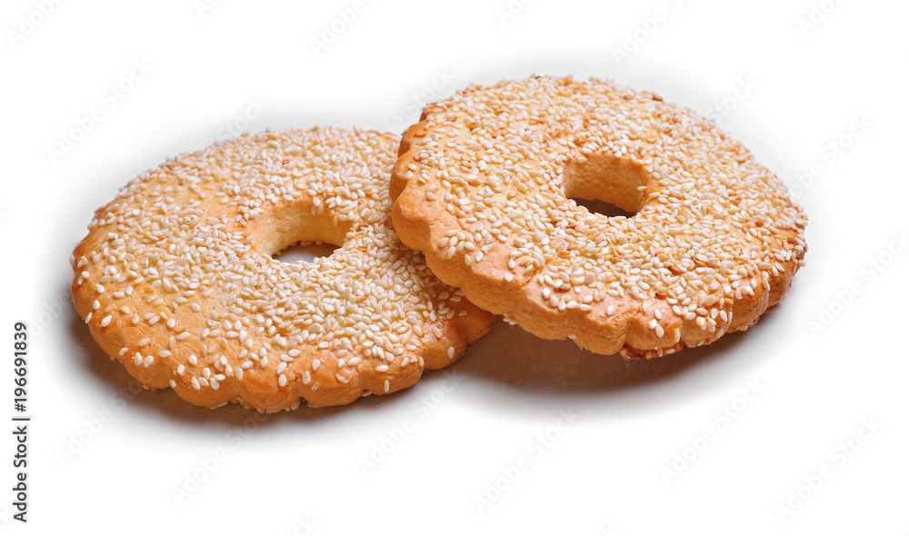 round gingerbread with sesame seeds lie on white paper round gingerbread with sesame seeds lie on white paper