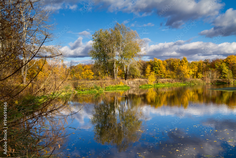 Beautiful autumn landscape - View from the river bank with reflection in water, the river Siverskyi Donets, north-east of Ukraine.