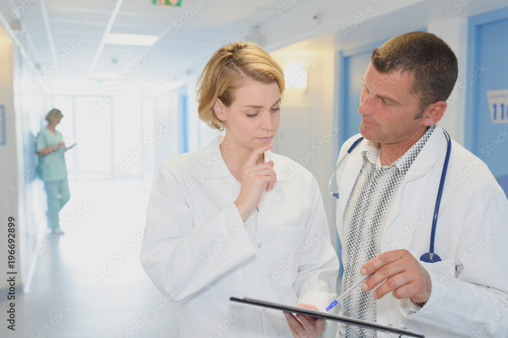 male doctor and female nurse in hospital corridor