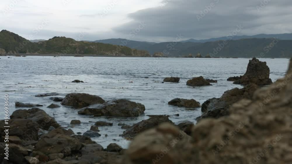 Pull focus rock to ocean on an overcast day. Pull focus rock to ocean on an overcast day.