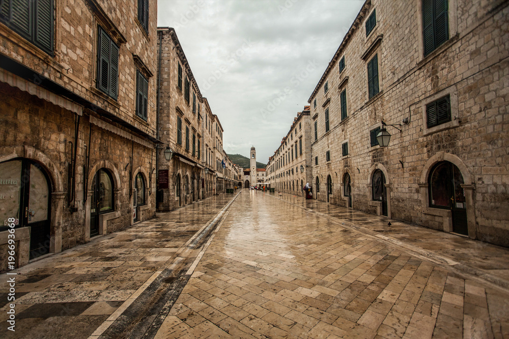 Stone walls and floor on the main street Stradun in Dubrovnik still not busy with the tourists in the early morning