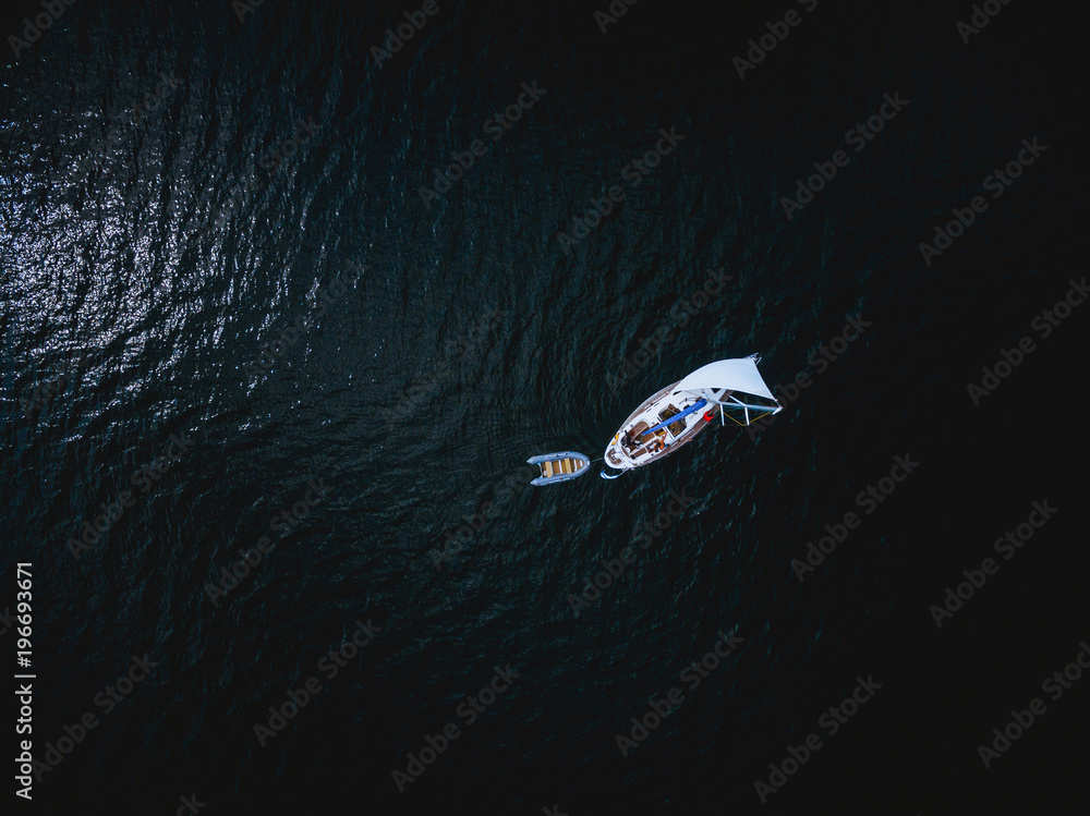 Aerial view of white yacht with little boat Aerial view of white yacht with little boat
