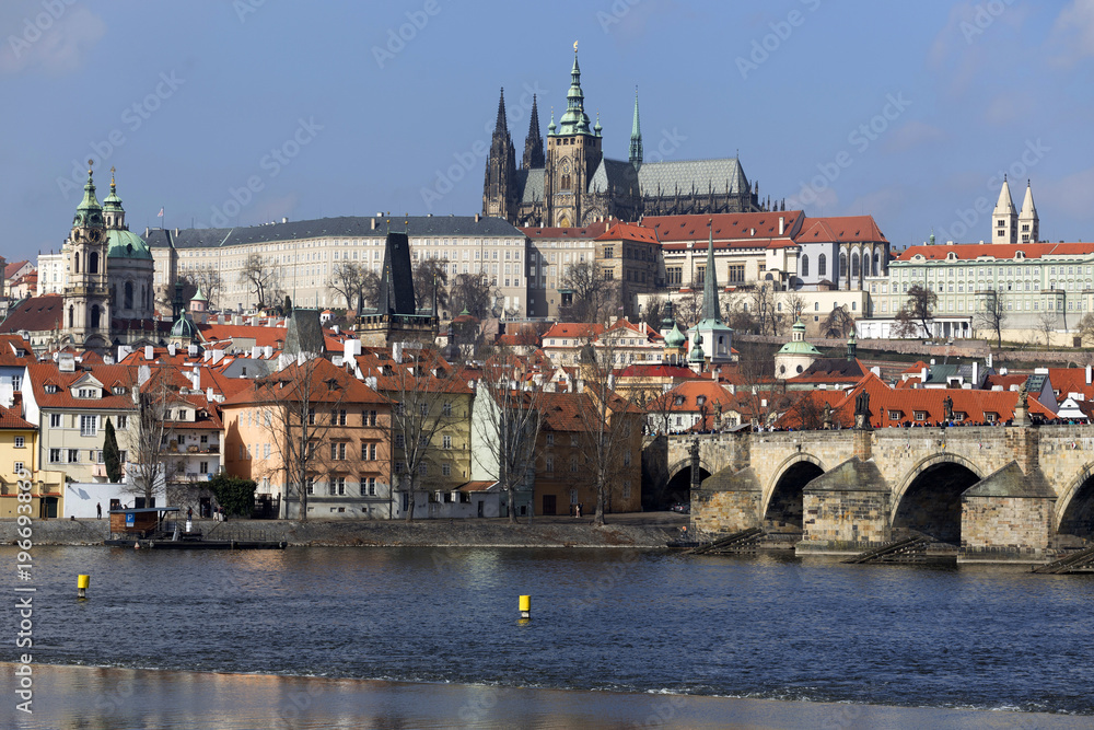 Fototapeta premium Early Spring Prague gothic Castle and Charles Bridge with the Lesser Town in the sunny Day, Czech Republic