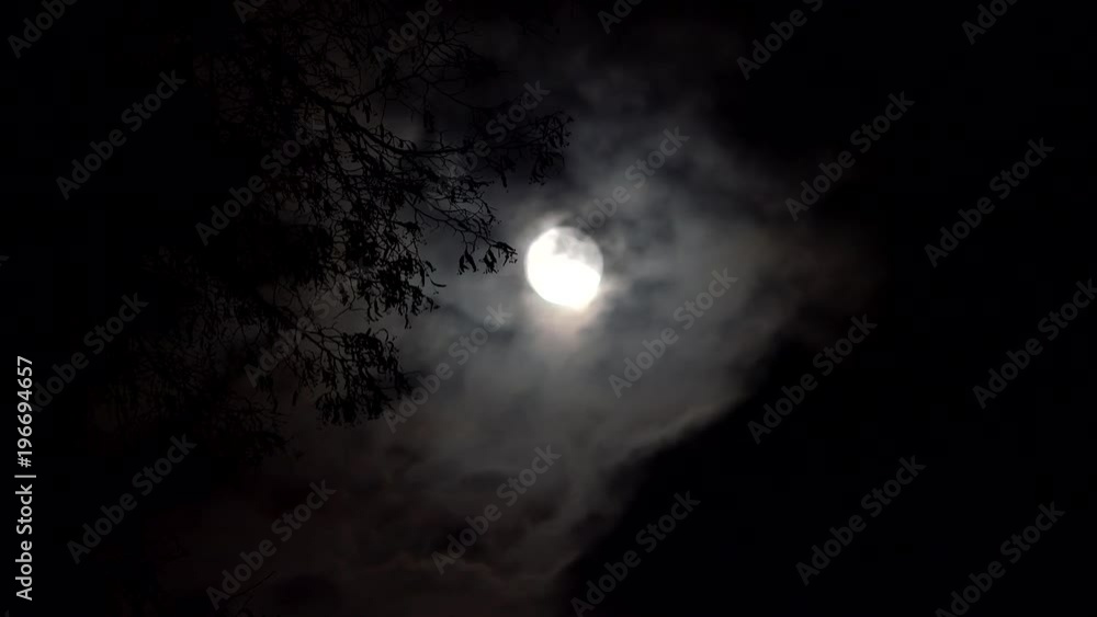 Dark clouds covering white fool moon, horror scene Dark clouds covering white fool moon, horror scene