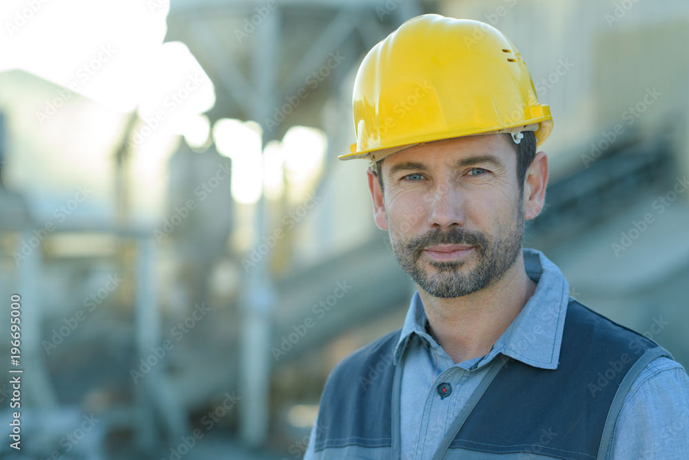 portrait of a confident worker in a factory portrait of a confident worker in a factory