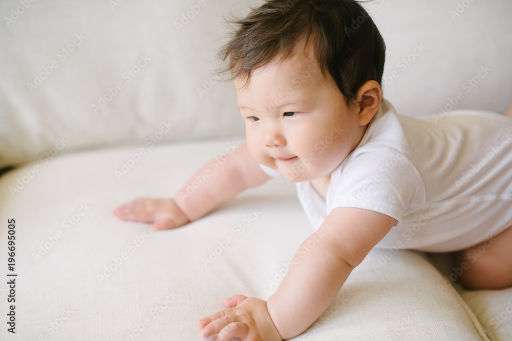 Baby trying to crawl on couch