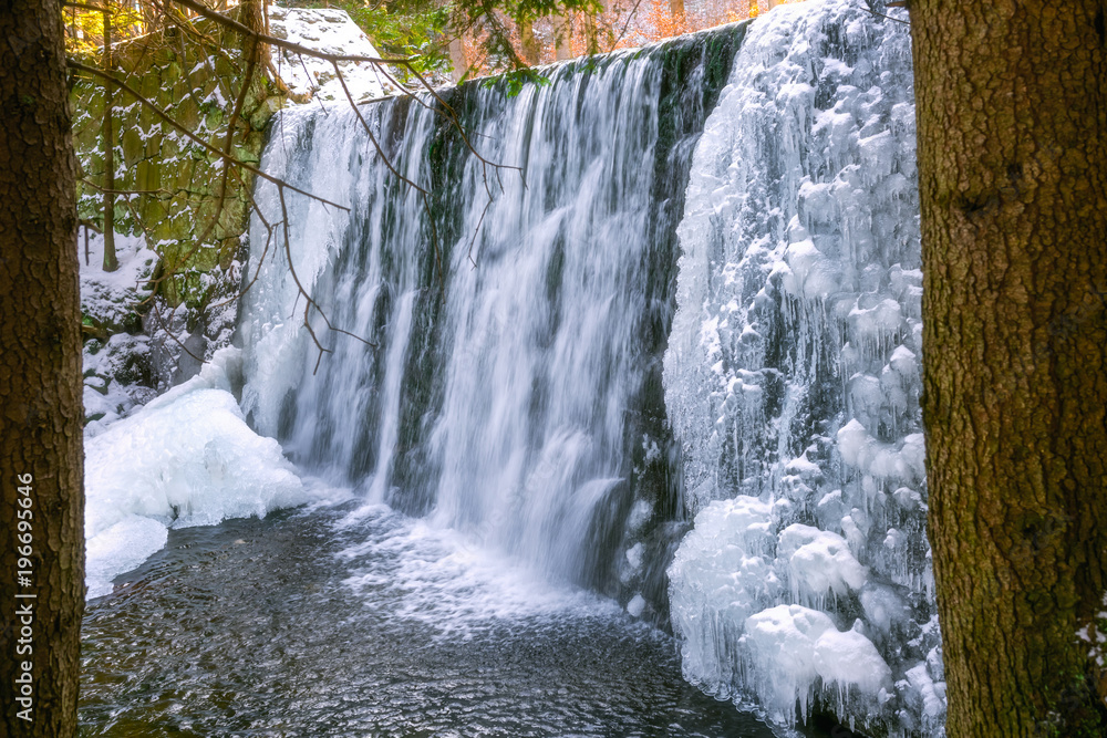 Naklejka premium Wild waterfall in winter
