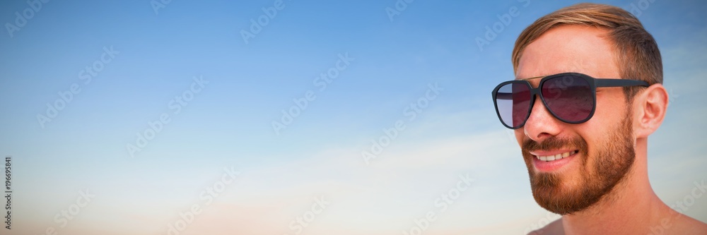 Composite image of fashionable man wearing sun glasses Composite image of fashionable man wearing sun glasses