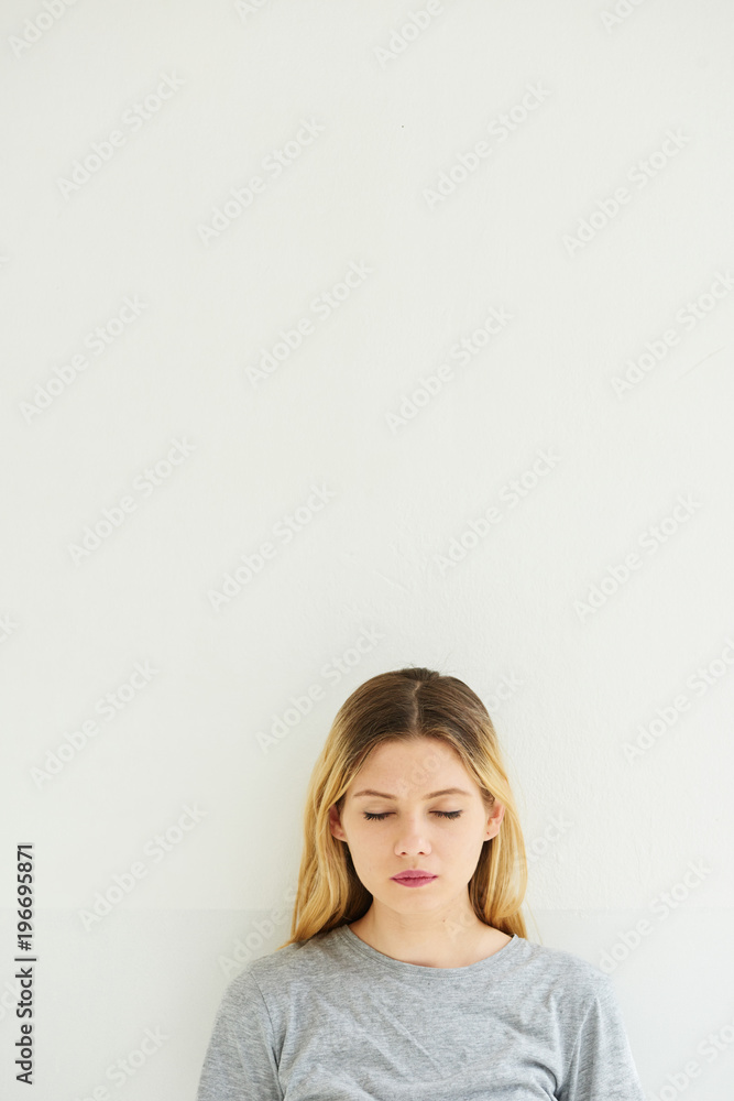 Blonde girl with eyes closed over white background. Blonde girl with eyes closed over white background.