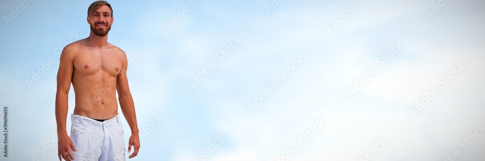 Fototapeta premium Composite image of portrait of smiling shirtless young man