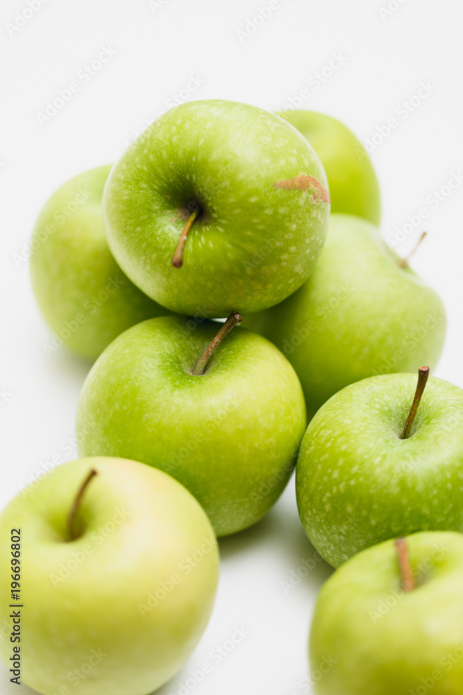 Close up shot of organic green yellow Granny Smith or Golden Delicious apples with little blemishes on white background Close up shot of organic green yellow Granny Smith or Golden Delicious apples with little blemishes on white background