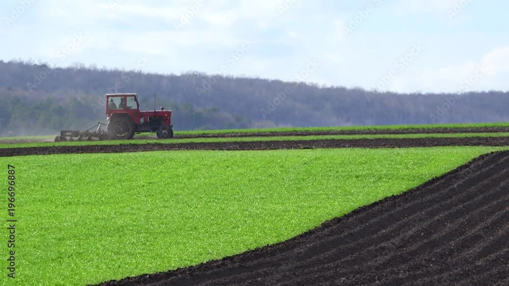 Tractor plowing the land in spring, ecological agriculture Tractor plowing the land in spring, ecological agriculture