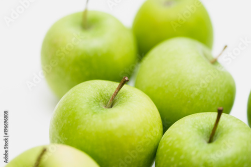 Close up shot of organic green yellow Granny Smith or Golden Delicious apples with little blemishes on white background