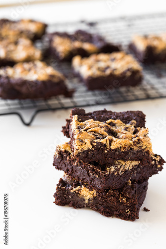 Chocolate Tahini Brownies Stacked in a White Table