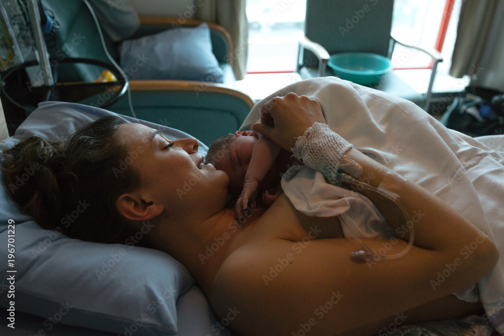 Brand new mother and child after delivery in hospital room Brand new mother and child after delivery in hospital room