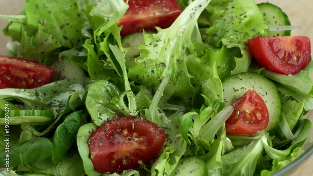 Fresh vegetables. Salad made from tomatoes,cucumbars, lettuce turning in a plate Fresh vegetables. Salad made from tomatoes,cucumbars, lettuce turning in a plate