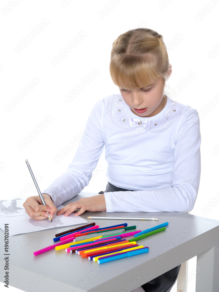 A little girl is drawing at the table. A little girl is drawing at the table.