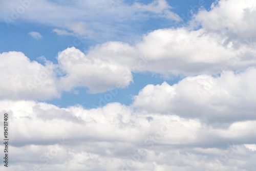 Cumulus and Cirrostratus clouds against a blue sky. © sheilaf2002