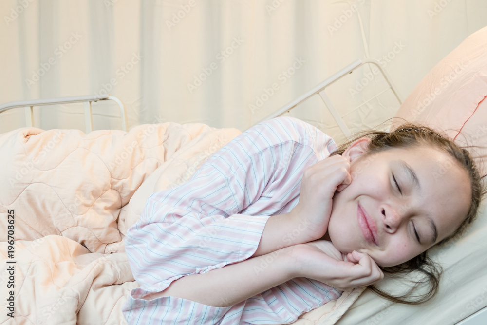 Cheerful mixed race tween girl in hospital bed Cheerful mixed race tween girl in hospital bed