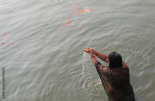 A woman bathes in Ganges river Varanasi. 