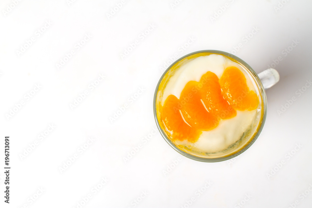 Desserts, A cup of yogurt and orange sauce with beans on white background