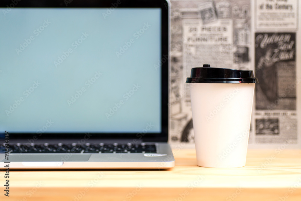 Fototapeta premium Laptop and coffee on wood table