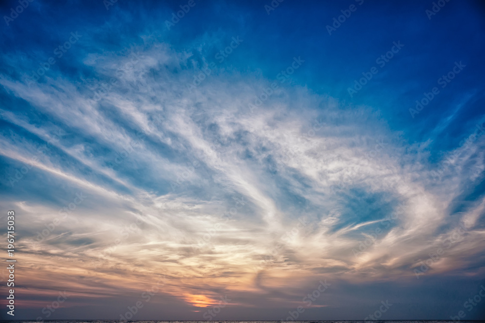 Sunset / sunrise with clouds and sea, light rays and other atmospheric effect