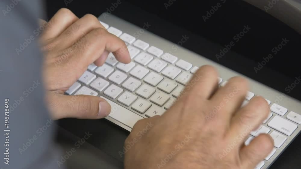 Hands typing on an apple computer keyboard