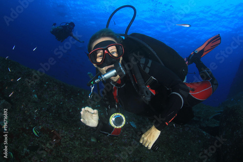 Female scuba diver underwater and fish