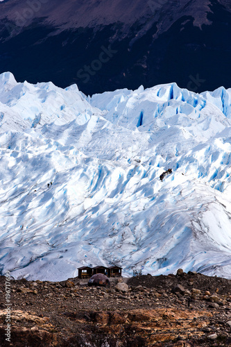 People climbing glacier, telephoto view, holiday travel. Global  photo