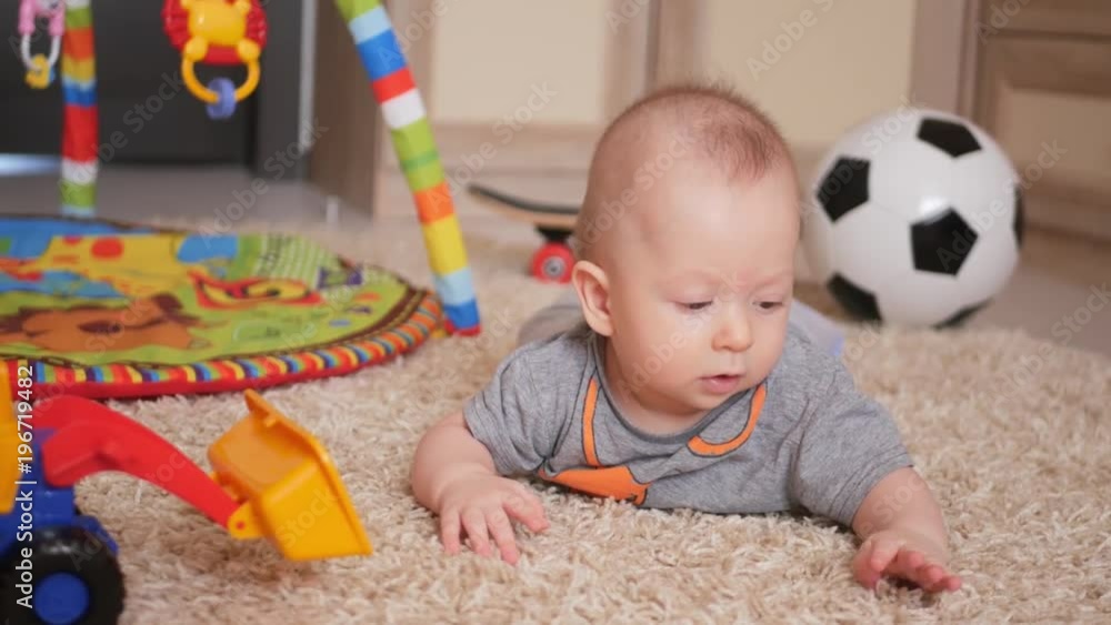 Funny little child playing with toys by the home