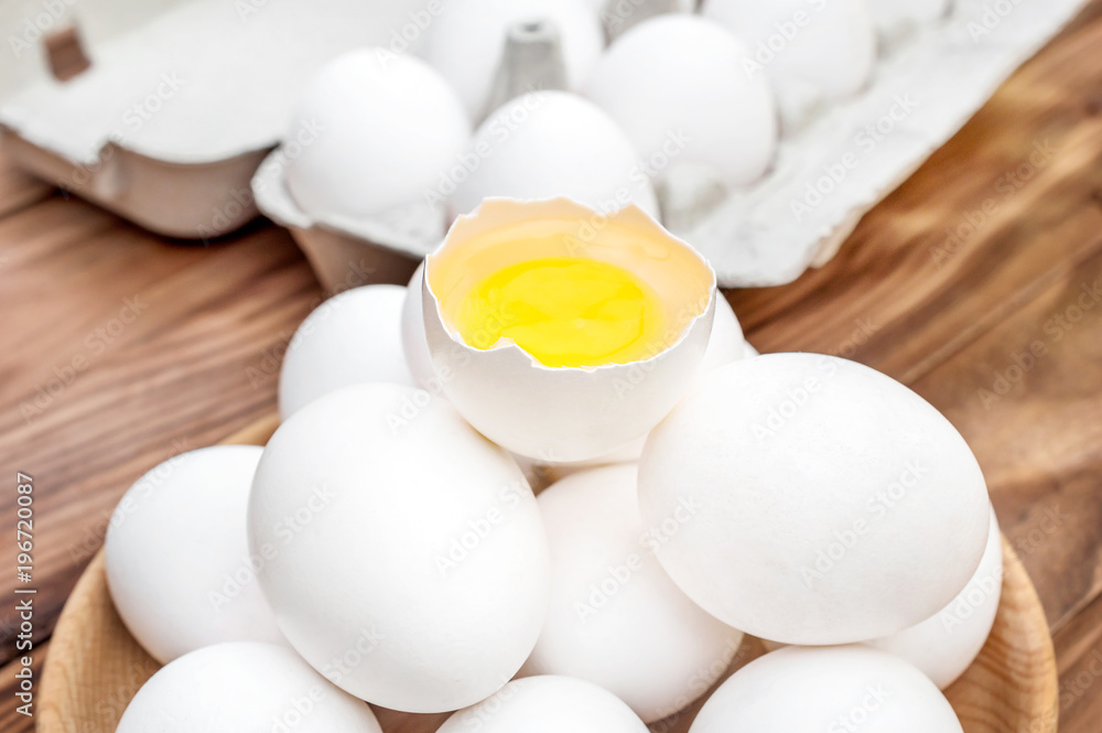 Broken egg on the heap of whole eggs. Close up. Broken egg on the heap of whole eggs. Close up.