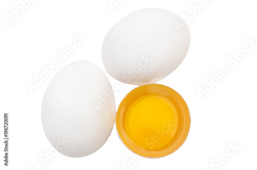One broken egg with two whole eggs isolated on white background. Top view.