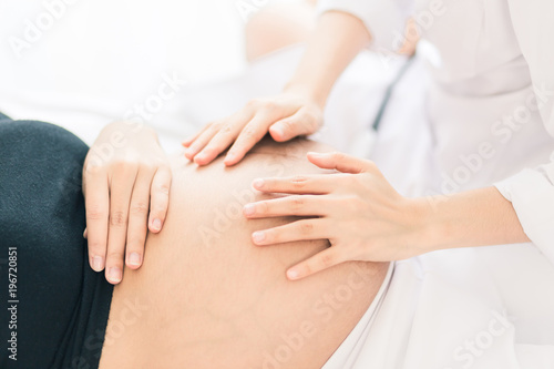 Female Obstetrician doctor Examination to a pregnant woman at hospital.