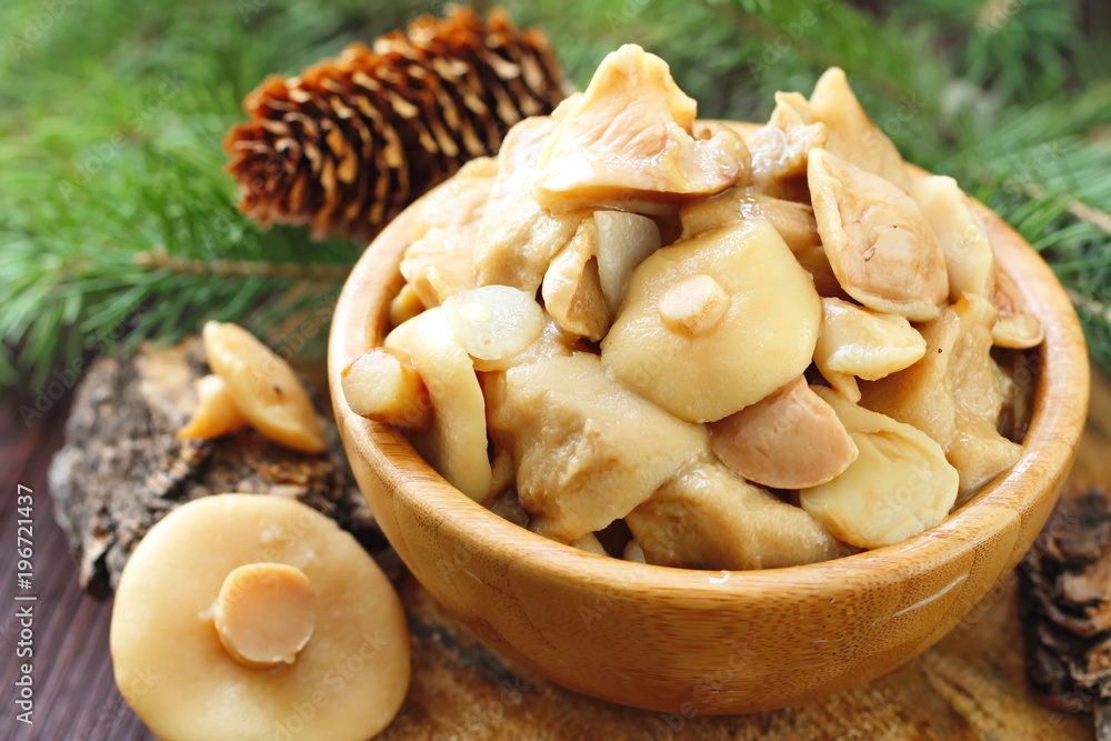 Pickled mushrooms in a wooden bowl Pickled mushrooms in a wooden bowl