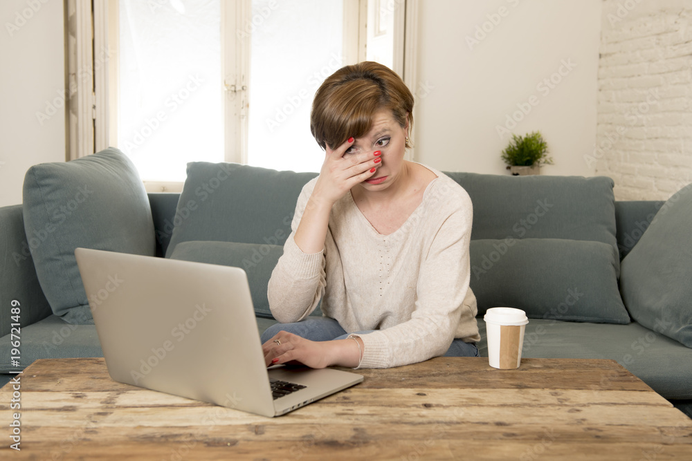 young attractive and busy woman at home sofa couch doing some laptop computer work in stress looking worried in entrepreneur lifestyle young attractive and busy woman at home sofa couch doing some laptop computer work in stress looking worried in entrepreneur lifestyle