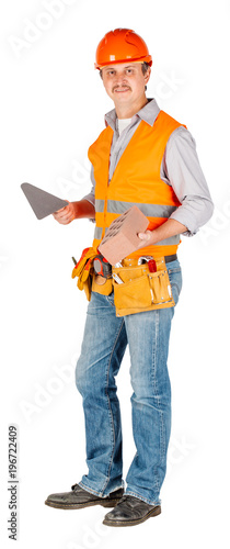 builder in a helmet holding a brick and trowel © kaninstudio