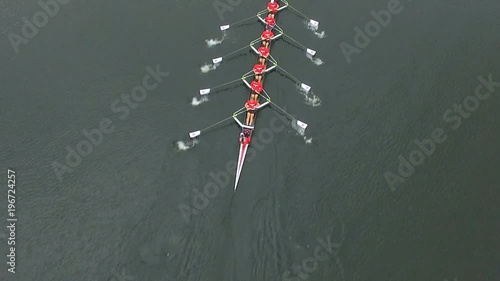Overhead aerial of rowing team in boat rowing together