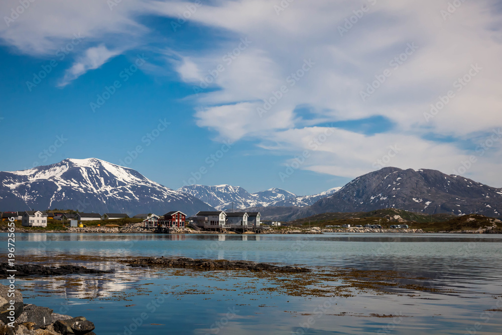 Village and Sea view on mountains in the background in Sommaroya, Norway