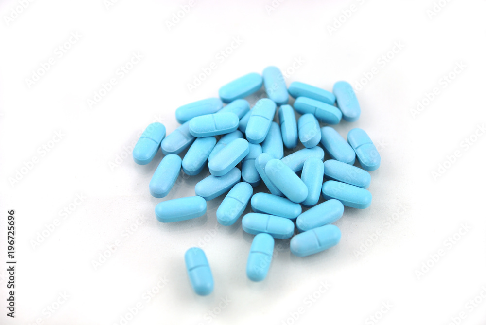 Oval blue tablets closeup on white background Oval blue tablets closeup on white background