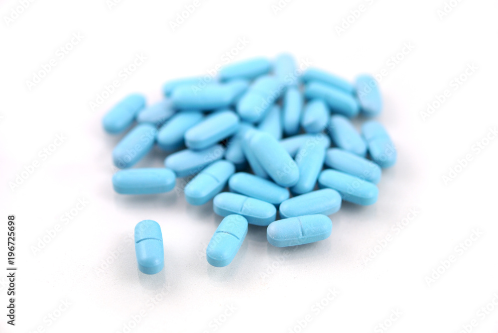 Oval blue tablets closeup on white background Oval blue tablets closeup on white background