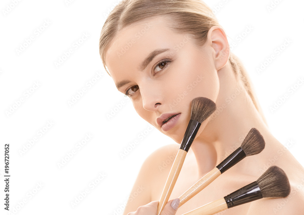 The pretty woman with cosmetic brushes on the white background The pretty woman with cosmetic brushes on the white background